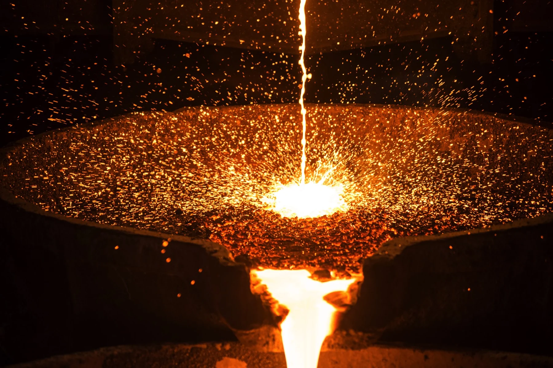 Molten metal being poured in an industrial foundry