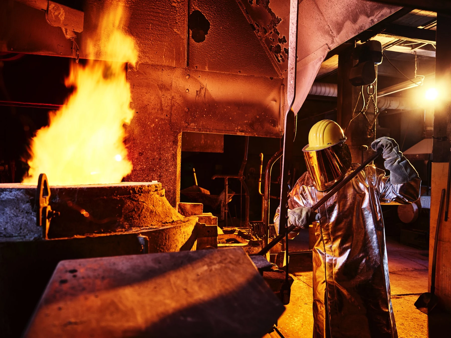 Industrial worker overseeing metal processing